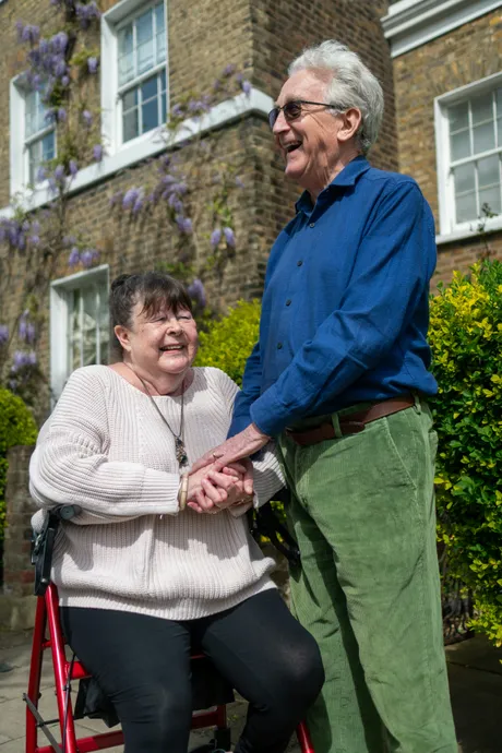 Caregiver holding hands with elderly woman
