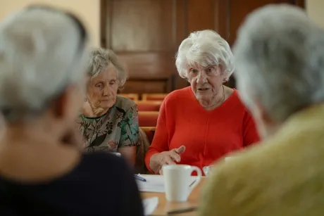 An elderly group of people having a discussion