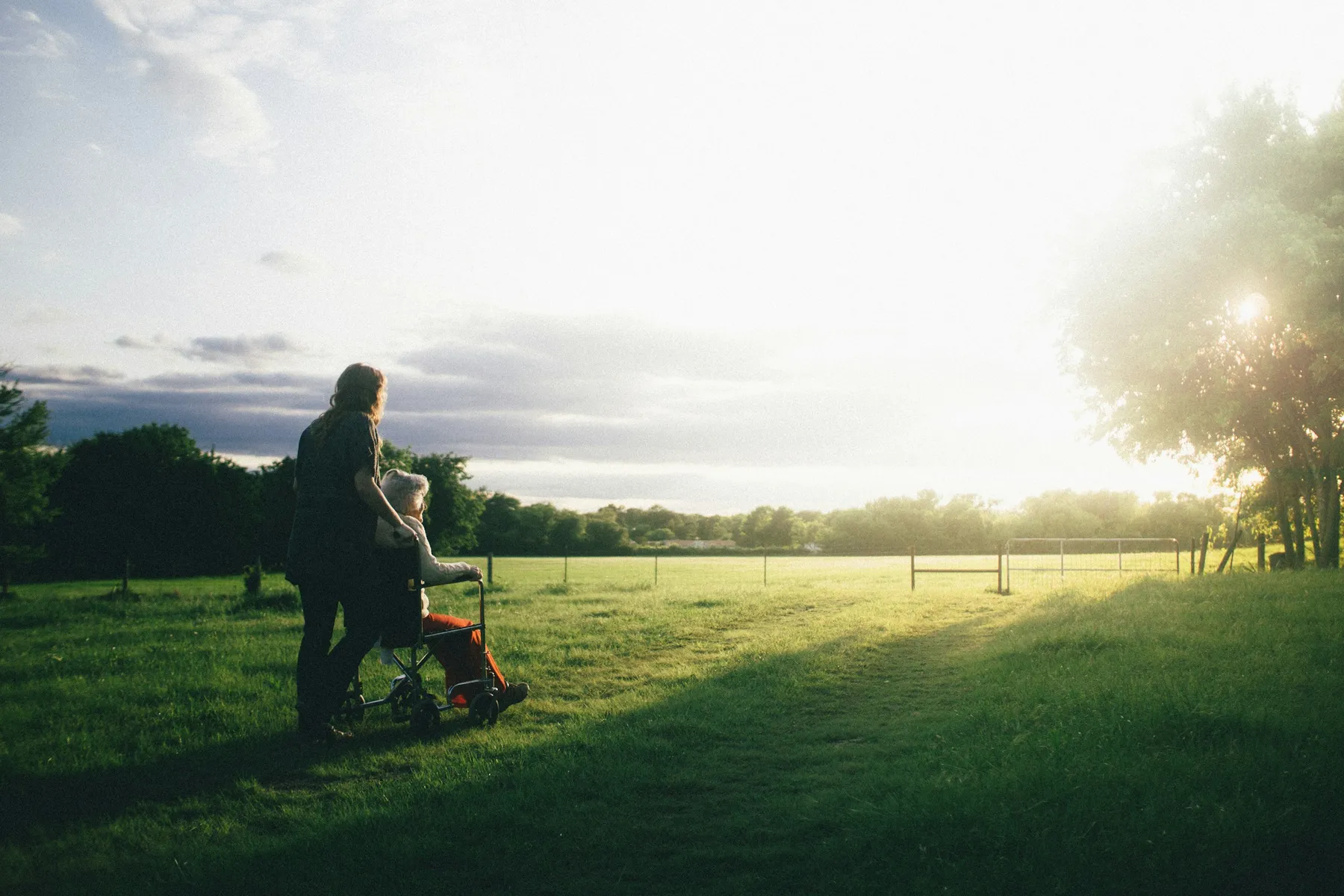 Photo of seniors looking out a beautiful farm field